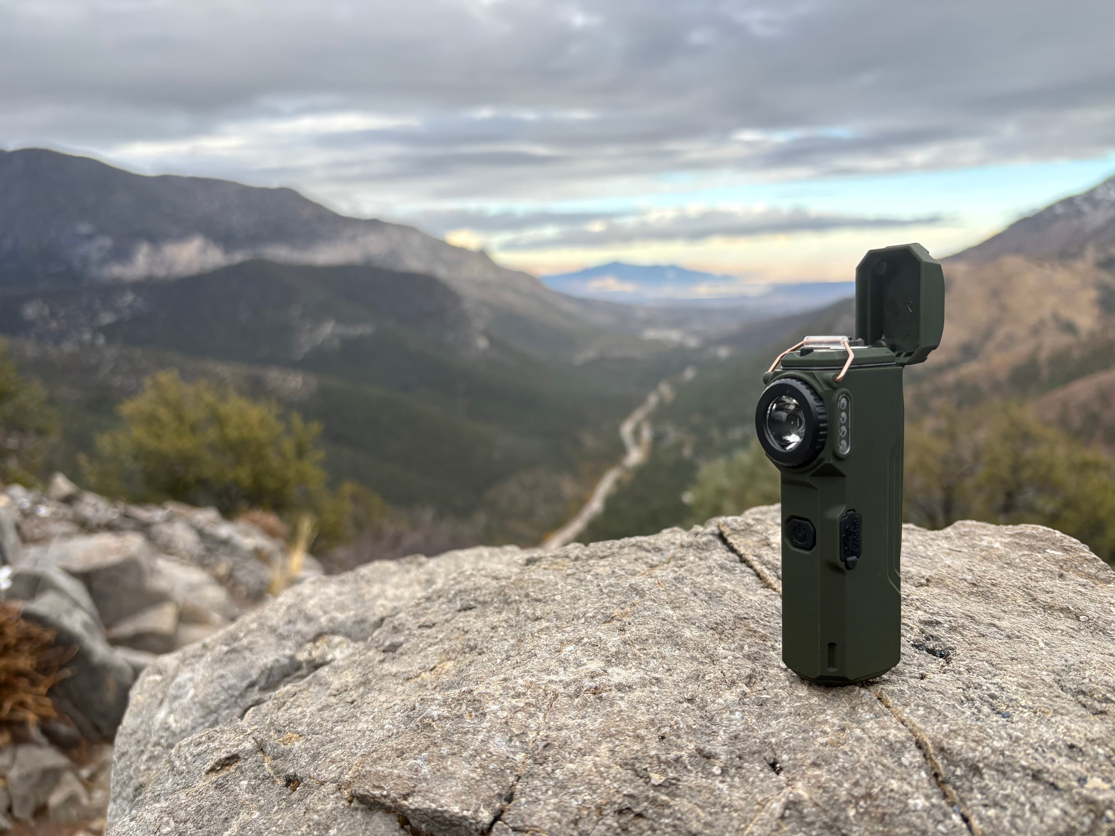 The Arc 80 on a rock ledge above a mountain valley