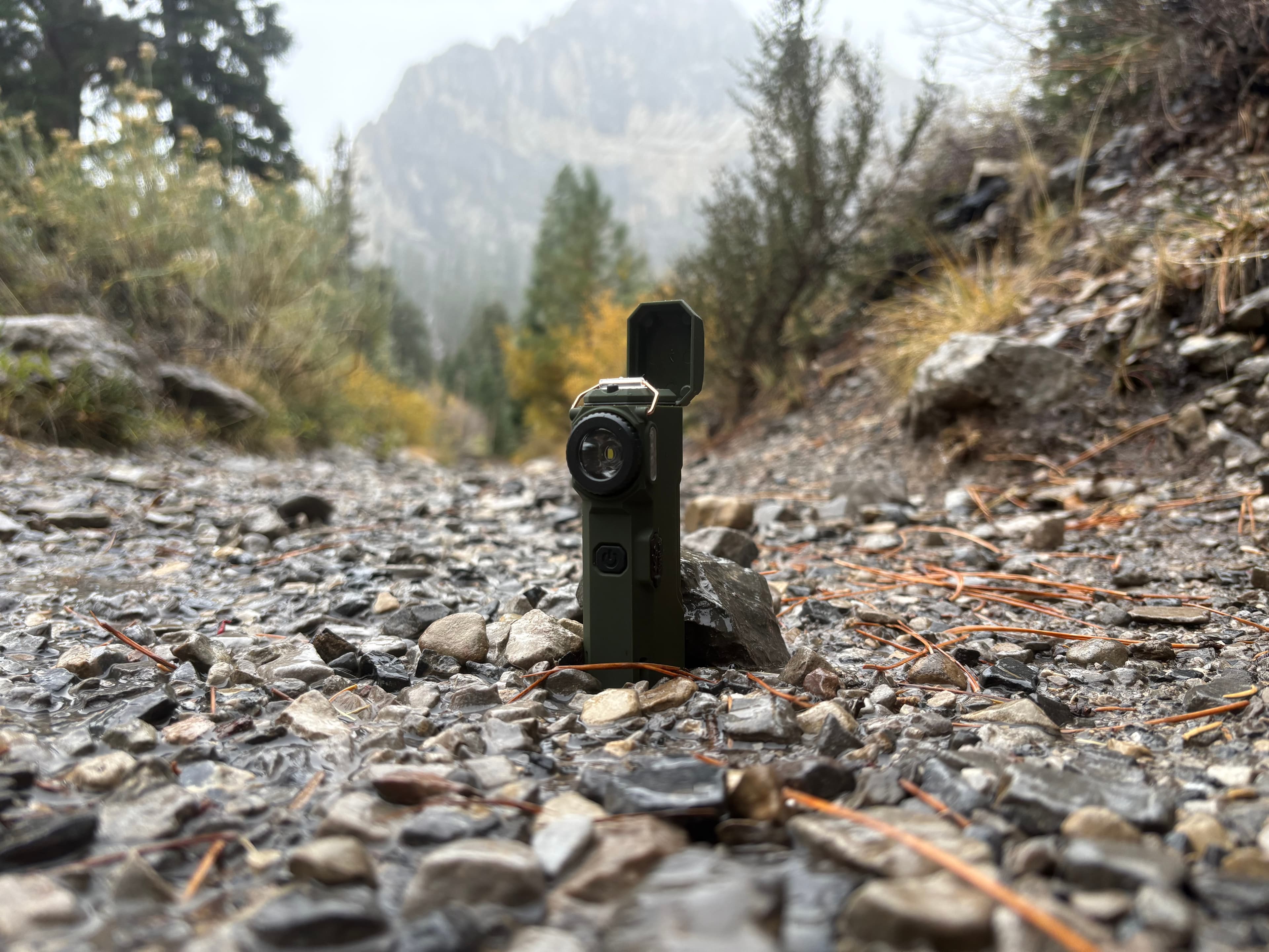 The Arc 80 standing on a rocky mountain trail with misty peaks behind